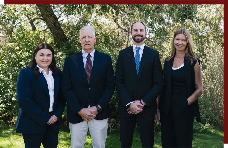 jbattorneys02 J&B Attorney's team photo in front of a wooded area