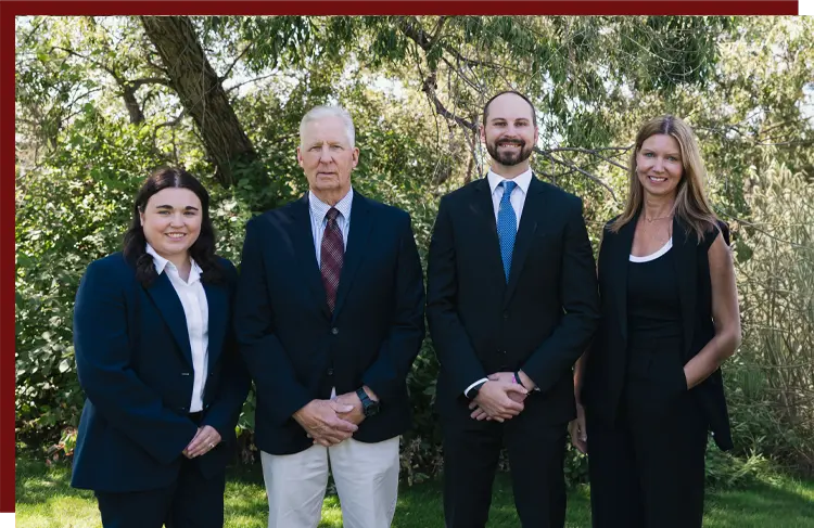 jbattorneys03 J&B Attorney's team photo in front of a wooded area
